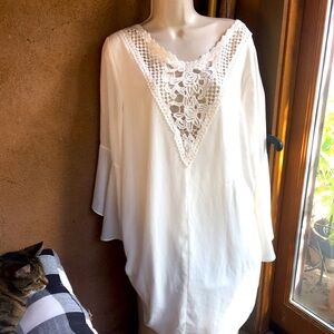 Elegant and simple. Creamy white with flared mid length sleeves. Size L